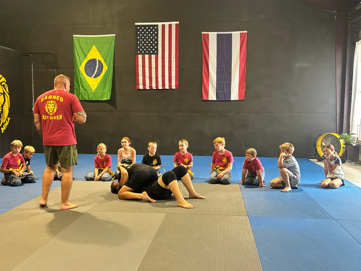 James Larremore walking the kids class through a grappling demonstration