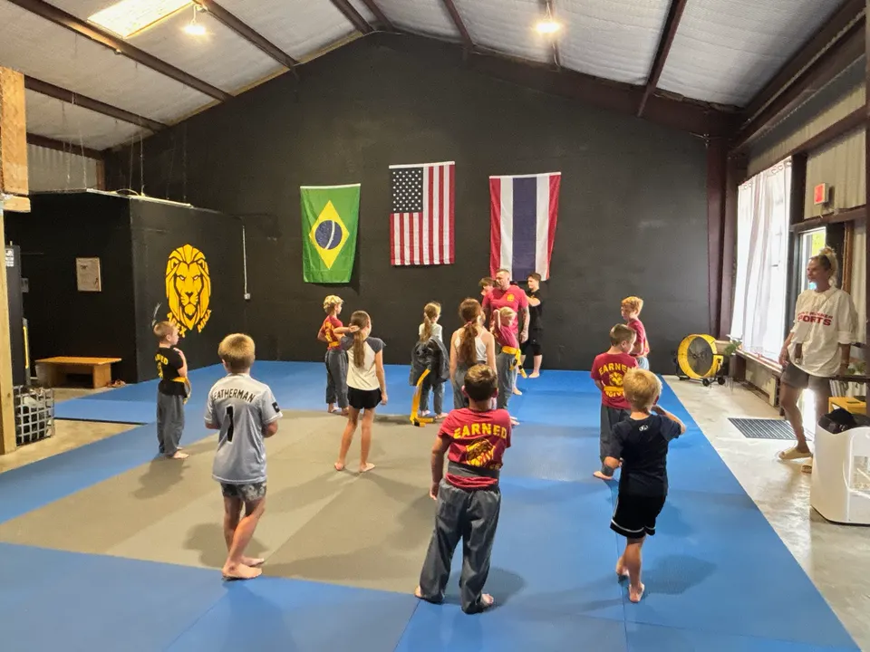 Kids lined up on the mats during an Apex MMA kids class